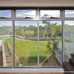 Glass windows overlooking green lawn