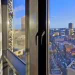 Glass windows and awnings with view of the city