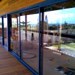Blue awnings and glass doors on wooden structure