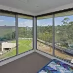 View of green lawns from upper floors with glass windows